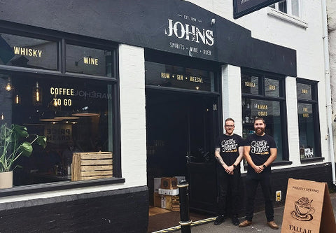 Johns Wines front of shop with owners